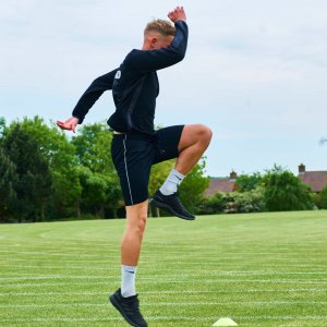 Client performing sports specific rehabilitation exercise